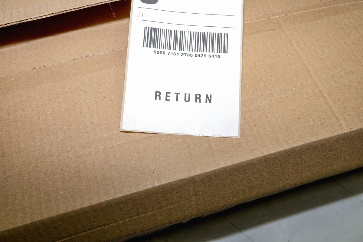 Online order return package sitting next to a receipt document