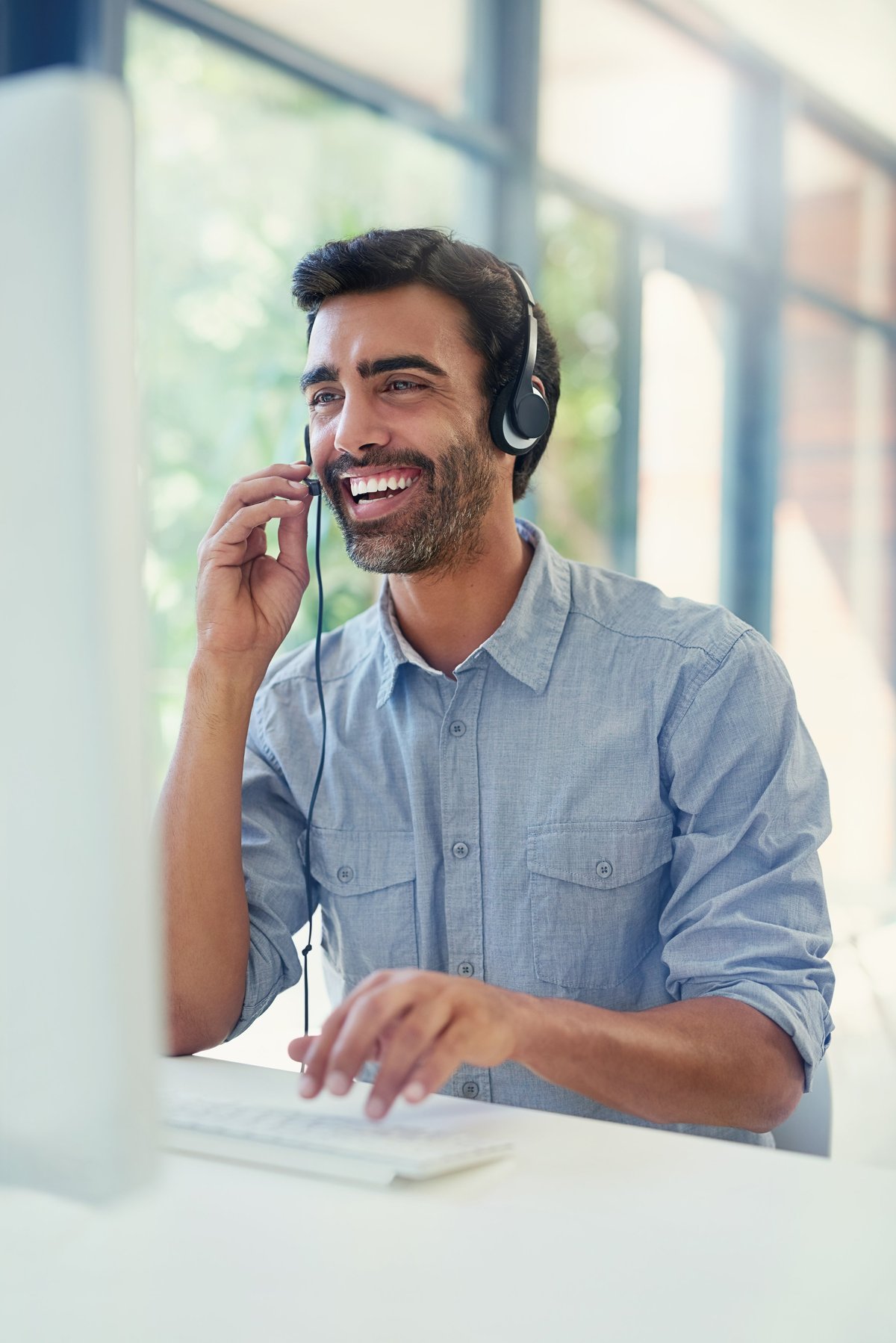 Customer service agent at a desk assisting a caller with service options
